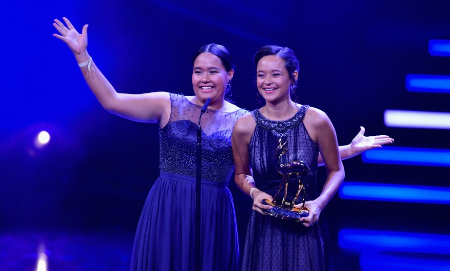 Teenage sisters Melati and Isabel Wijsen of Bali have received many honors for their efforts to ban plastic bags. Above: They accept the 2017 "Award for Our Earth" from Germany's Bambi Awards.