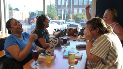 Readers pick out books during an event hosted by Good Girl Books on July 15, 2026.