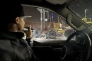 Vincent Williams shines flashlight on dump pile at 26th and Peralta in West Oakland