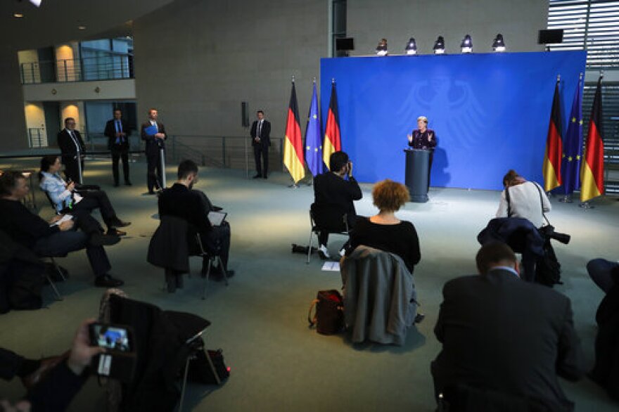 Journalists sitting far apart at a press conference in Germany