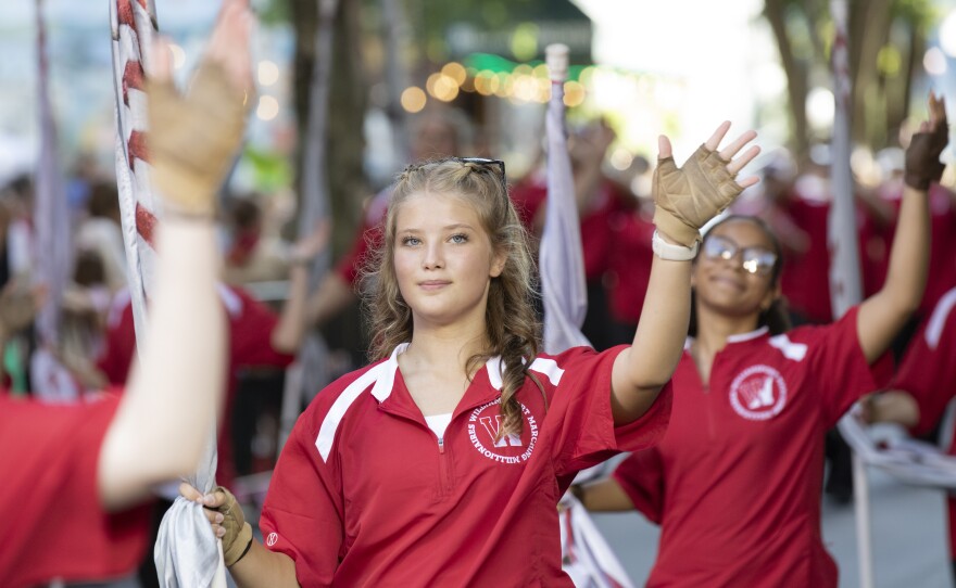 Members of the Williamsport Area High School's Marching Millionaires color guard walk in the Little League World Series parade.