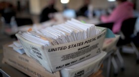 Election officials count absentee ballots on Nov, 3, 2020, in Beloit, Wis.