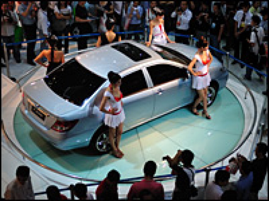 Visitors view an F3DM electric vehicle at the 2008 China High-Tech Fair on Oct. 14, 2008, in Shenzhen.