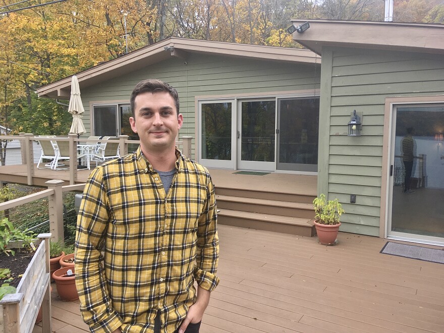 Bill Gerlach stands outside the Honeoye, NY, house where the business behind his app, HereNOW Help, is based.