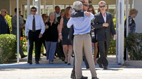 Mourners exit the Parker Playhouse following a memorial service for John Stevens and his wife Michelle Mishcon, Friday, Aug. 19, 2016, in Fort Lauderdale, Fla. A Florida sheriff's office said Friday, that Austin Harrouff, 19, will be charged with two counts of first-degree murder in the couples death, raising the possibility of the death penalty. (Mike Stocker/South Florida Sun-Sentinel via AP)