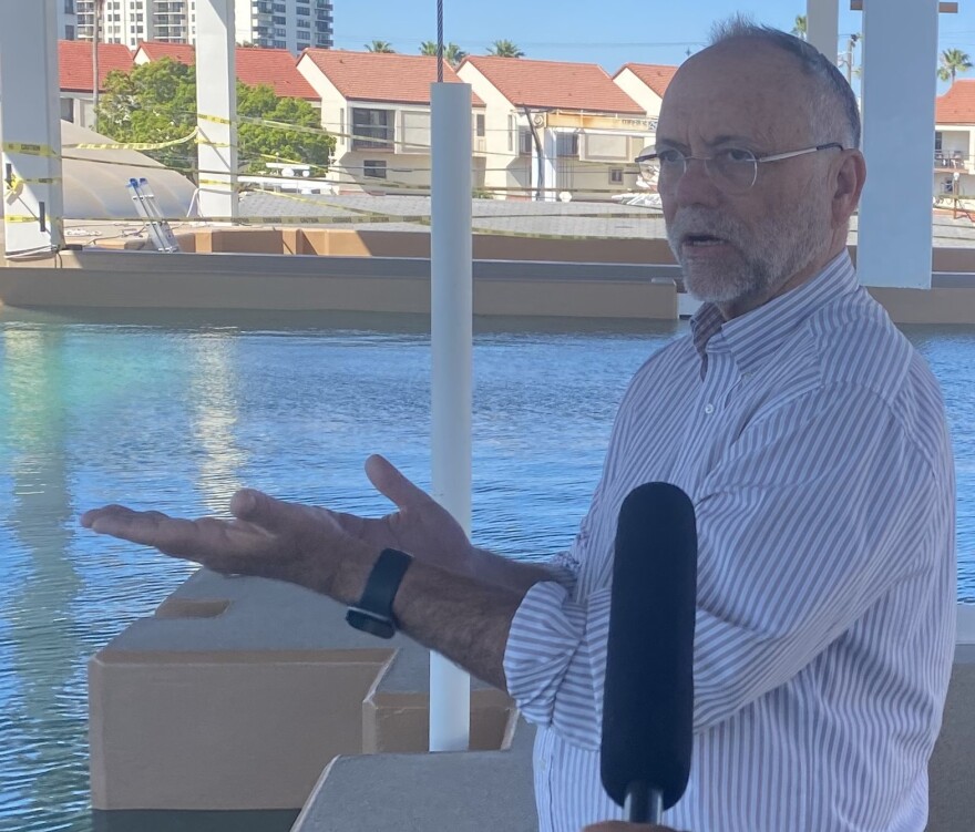 Man gesturing toward the water