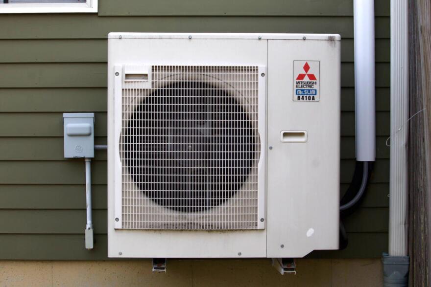 The outdoor unit of Jose Juste's heat pump system in Newburyport. (Miriam Wasser/WBUR)