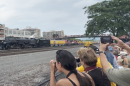 People waved as the Big Boy came through the rail tracks outside of the Railroaders Memorial Museum in Altoona on Wednesday, July 8. Many people stood on the  pedestrian bridges over the train tracks and nearby building rooftops. 