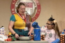 Julie Belanger, professor of chemistry at King's College, guides Rosely Espinoza , 7, of Wilkes-Barre, through a liquid nitrogen demonstration, in which a flower became brittle.