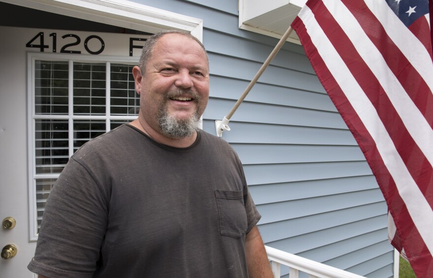 Scott Jones, executive board chair, Tiny Home Community Development stands in the doorway of one of the half dozen homes in the Hammer Tiny House Community Tuesday, June 18, 2019, in Greensboro, N.C.