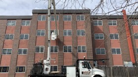 Nick Avtges in a bucket truck outside his wife Marion's window. (Courtesy) 