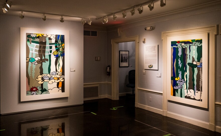 Two prints by artist Roy Lichtenstein hang in a gallery.
