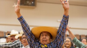 A Handgame participant holds up bones for all players to see on July 17, 2024.