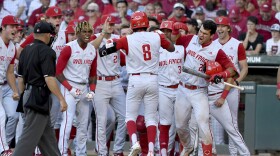 North Carolina State's Jose Torres (8) is greeted by teammates after hitting a go-ahead home run against Arkansas in the ninth inning of an NCAA college baseball super regional game, Sunday, June 13, 2021, in Fayetteville, Ark.