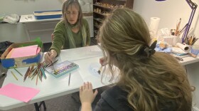 Art therapist Janet Osborn gives Leah simple directions in an art therapy session. 