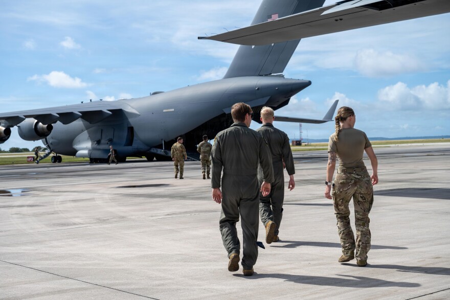 U.S. Air Force Airmen assigned to the 39th Airlift Squadron walk toward a C-17 Globemaster III assigned to the 14th Airlift Squadron prior to a community engagement event during Exercise Palmetto Reach at Saipan International Airport, Jan. 20, 2026.  (U.S. Air Force photo by Airman 1st Class Adrien Tran)