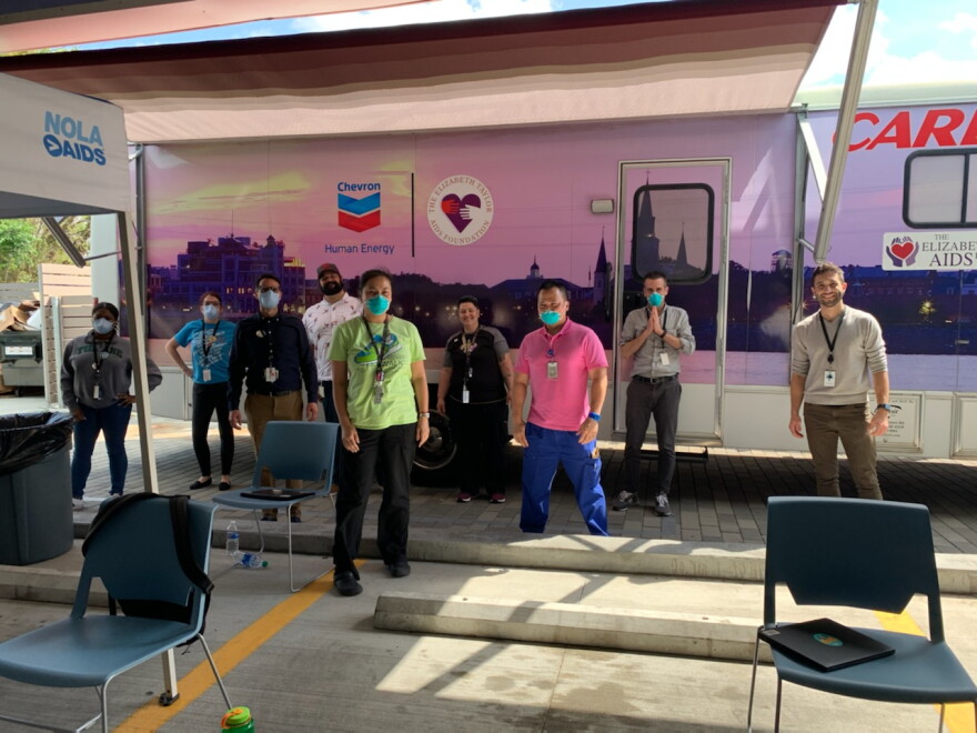 Staff at CrescentCare clinic in New Orleans pose outside the mobile unit they've established to test for COVID-19.  