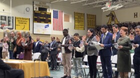 People holding their hand up while giving Oath of Allegiance, the final step to giving citizenship at a ceremony in Kettering on February 12.