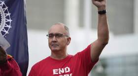 United Auto Workers President Shawn Fain raises his fist at a rally in Detroit on Sept. 15, 2023. (Paul Sancya/AP)