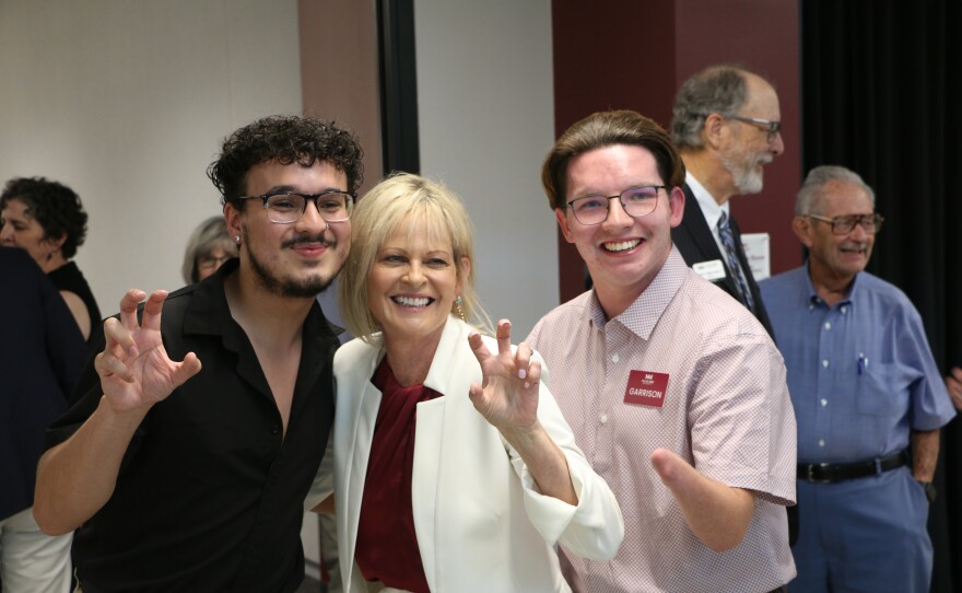 New president Lynne Murray posing with students