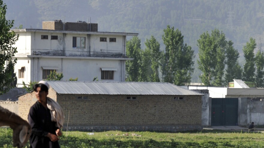 A Pakistani shepherd in Abbottabad walks past the hideout of al-Qaida leader Osama bin Laden, who was killed in a U.S.-led ground operation early Monday.