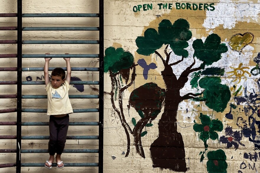 A boy plays in the courtyard of an abandoned school used by volunteers for hosting Syrian and Afghan refugees in Athens on July 1, 2016. (Aris Messinis/AFP/Getty Images)
