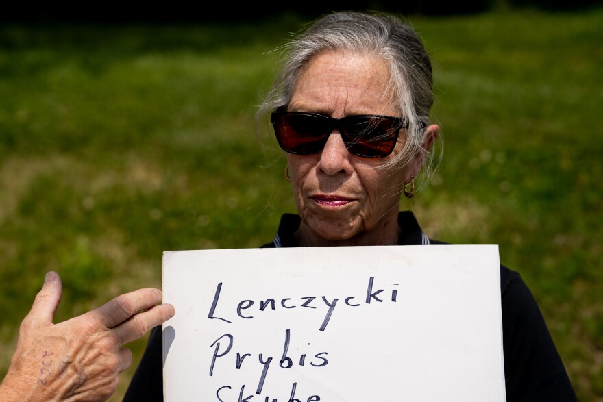 Lena Woltering, 75, of Belleville, holds a sign bearing the names of priests who allegedly abused minors — including Fred Lenczycki, the first U.S. Catholic priest to be labeled sexually violent when he was convicted in Illinois for abusing two Missouri boys in the ‘90s — on Tuesday, May 23, 2023, during a press conference outside of the Cathedral of Saint Peter in Belleville. The press conference was in response to a nearly 700-page Illinois Attorney General report that shows Catholic dioceses in Illinois under-reported number of abusive priests over roughly seven decades.