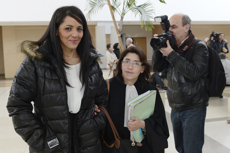 Bouchra Bagour, left, leaves a court house with her lawyer Gaelle Genoun.