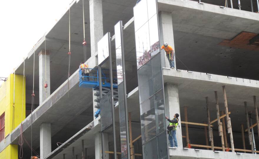 Harnesses and lines protect workers on the edge of a building on Google's new campus under construction in South Lake Union.