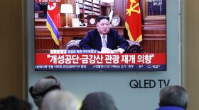 People watch a TV news on a screen showing North Korean leader Kim Jong Un delivering his New Year's speech, at Seoul Railway Station in Seoul, South Korea, on Tuesday. Ahn Young-joon/AP