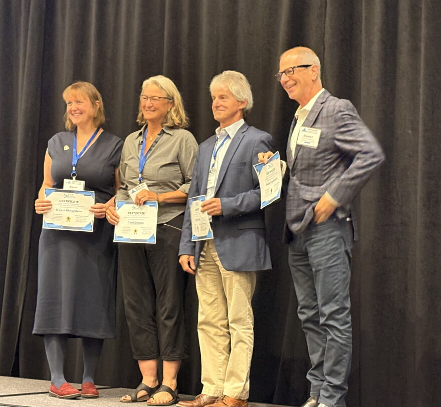 (L-r) Breeze Richardson, Executive Director of Aspen Public Radio; Tami Graham, Executive Director of KSUT Public Radio; Steve Zansberg, legal counsel representing the Colorado stations in the lawsuit, and Colorado Public Radio President Stewart Vanderwilt accept the Julie J. Boucher Community Honor Roll Award at a reception in Denver in September, 2026.