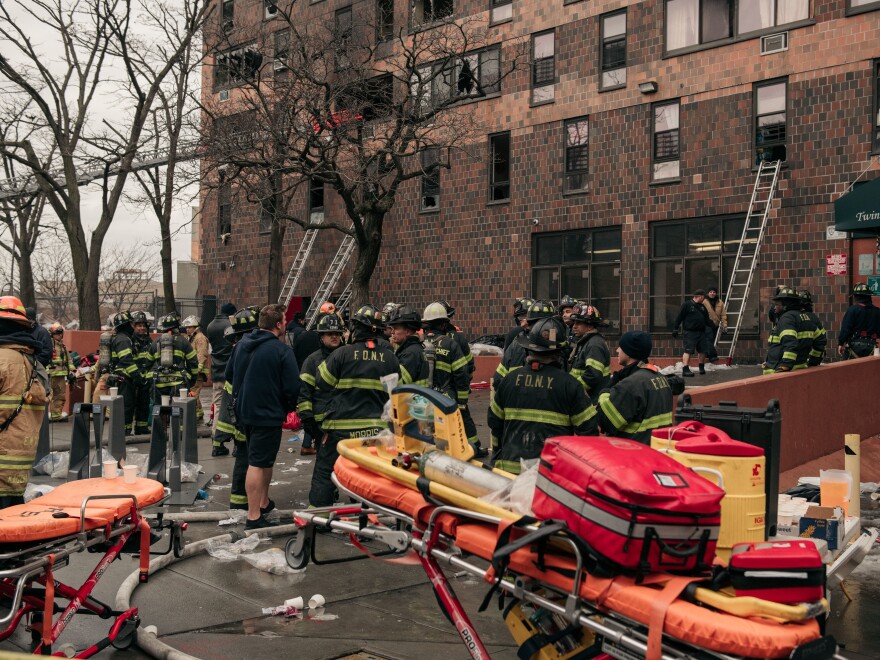 Emergency first responders remain at the scene of an intense fire at a 19-story residential building that erupted in the morning on Jan. 9, 2022 in the Bronx borough of New York City.