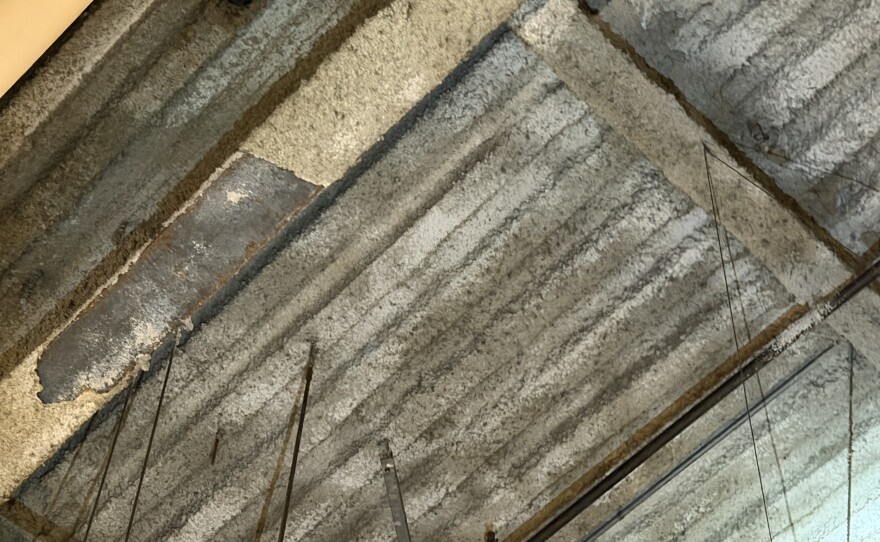 Fire suppression coating has chipped away from persistent leaks in the ceiling.