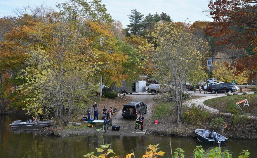 Law enforcement officials prepare to search the Androscoggin River in Lisbon Falls on Friday.