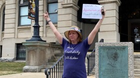 Woman holding sign and hangar