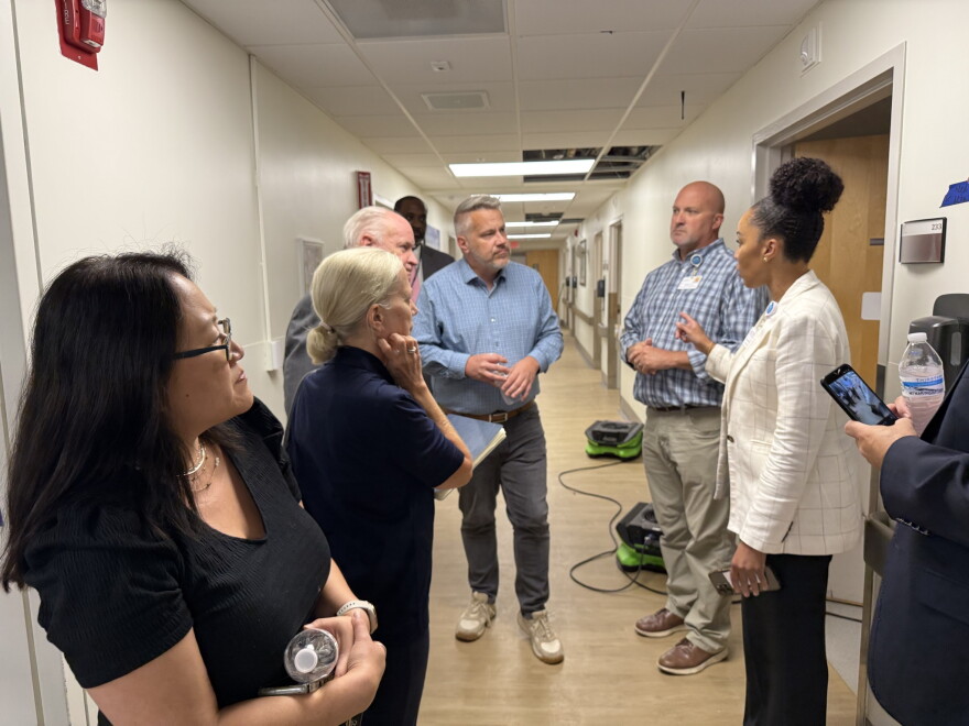 Eight people standing in a hallway