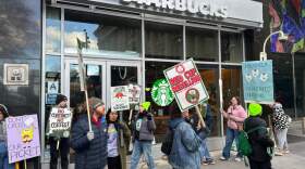 People picket at a Starbucks in New York on Friday, Nov. 14, 2025, as striking workers call for a union contract. (Ted Shaffrey/AP)