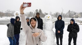 UConn freshman Thomas Maxwell photographs his fellow classmates after they built two snowmen on the edge of the school’s Mirror Lake. “We were throwing snowballs at each other,” said Colin Slavin (second from right) when the group decided to build a snowman. They built a second, they said, because they didn’t want the first to be lonely. Classes were canceled February 28, 2023, as 4-8 inches of snow fell across Connecticut Monday night into Tuesday morning in the first major snowfall of the season.