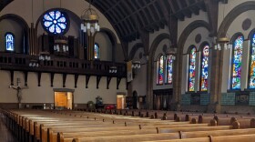 Inside Saint Aloysius Church shows pews and stained glass