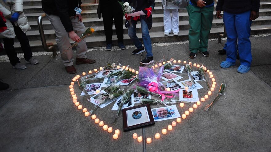 Health care workers light candles outside Mount Sinai Hospital in New York City on April 10 as they mourn and remember their colleagues who have died during the COVID-19 pandemic.