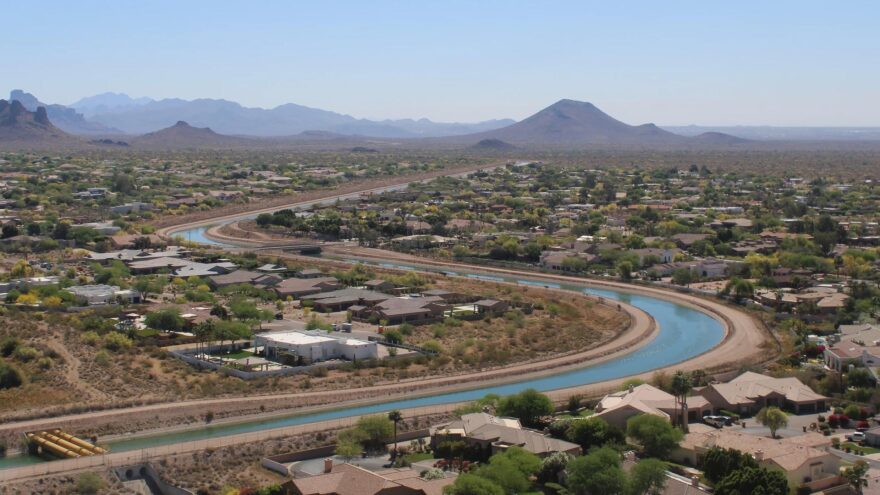 The Central Arizona Project canal winds through a neighborhood in the Phoenix area on March 26, 2026. A new plan includes mandatory cutbacks to the Colorado River Water carried by the canal.