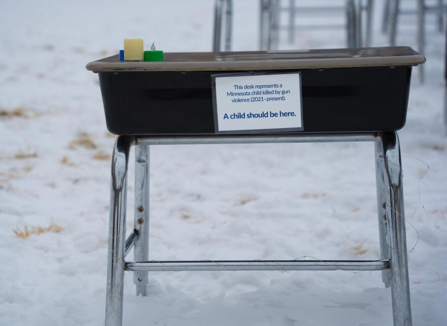 Desks representing children lost to gun violence line the Minnesota Capitol lawn Feb. 24, 2026, as lawmakers consider gun bills.