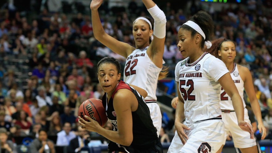 Erica McCall of the Stanford Cardinal drives against Tyasha Harris and A'ja Wilson of the South Carolina Gamecocks in the second half Friday during the semifinal round of the 2017 NCAA Women's Final Four in Dallas.