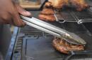 Eric Farley, of the Boys and Girls Club, sears a piece of grilled pork at the World Championship Barbecue Cooking Contest, Friday, May 17, 2024, in Memphis, Tenn. (George Walker IV/AP)
