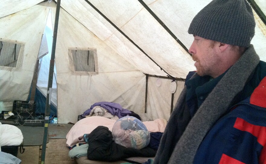 Tent City 3 resident Jeff Roderick shows off a group tent at the homeless camp.