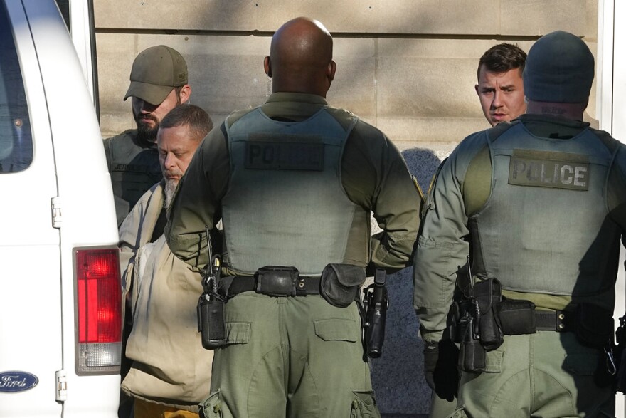 Officers escort Richard Matthew Allen, out of the Carroll County courthouse following a hearing, Tuesday, Nov. 22, 2022, in Delphi, Ind. Allen was charged last month with two counts of murder in the killings of Liberty German, 14, and Abigail Williams, 13.