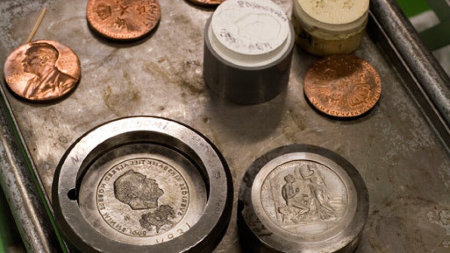 The Nobel Prize gold medal during manufacture at the Swedish Mint. Each laureate receives the medal, which has the likeness of Alfred Nobel on its face.