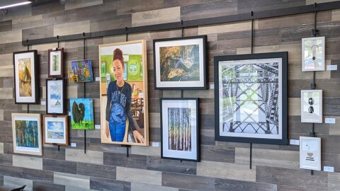 Framed artwork against a grey tiled wall