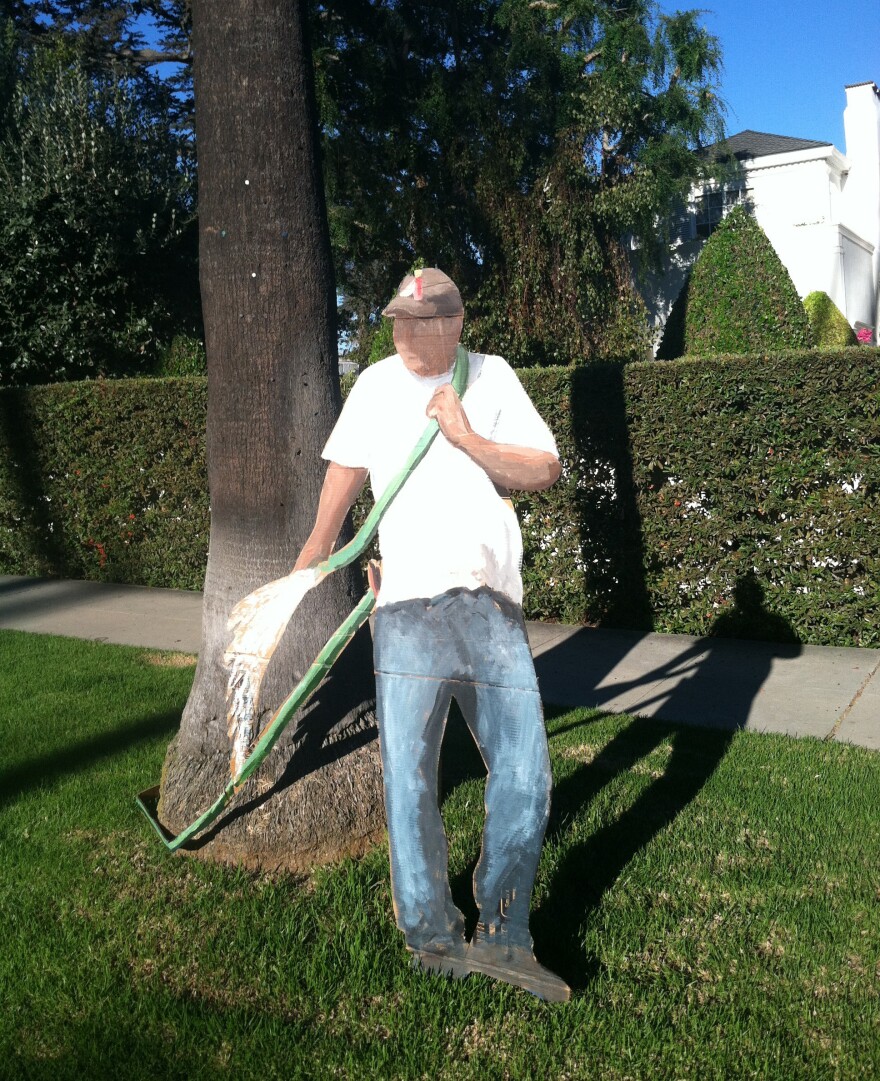 Gomez makes life-size cardboard cutouts of laborers — such as this "gardener" on North Beverly Drive — and leaves them on manicured lawns.