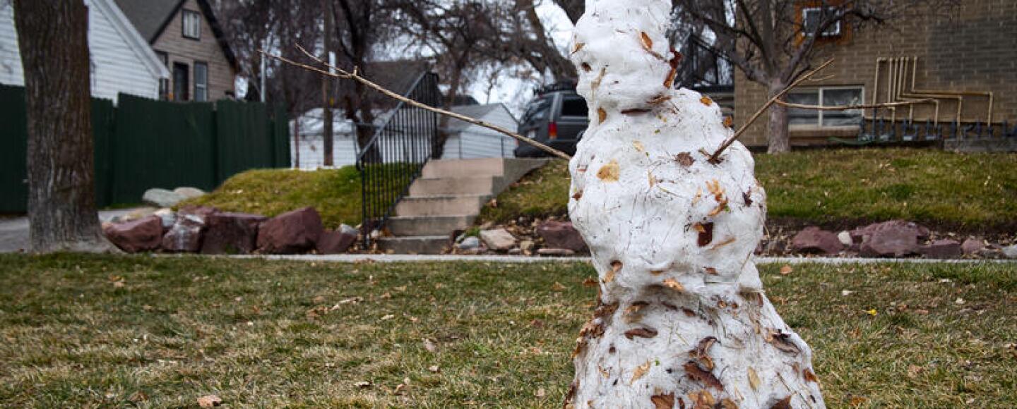 A photo of a melting snowman.